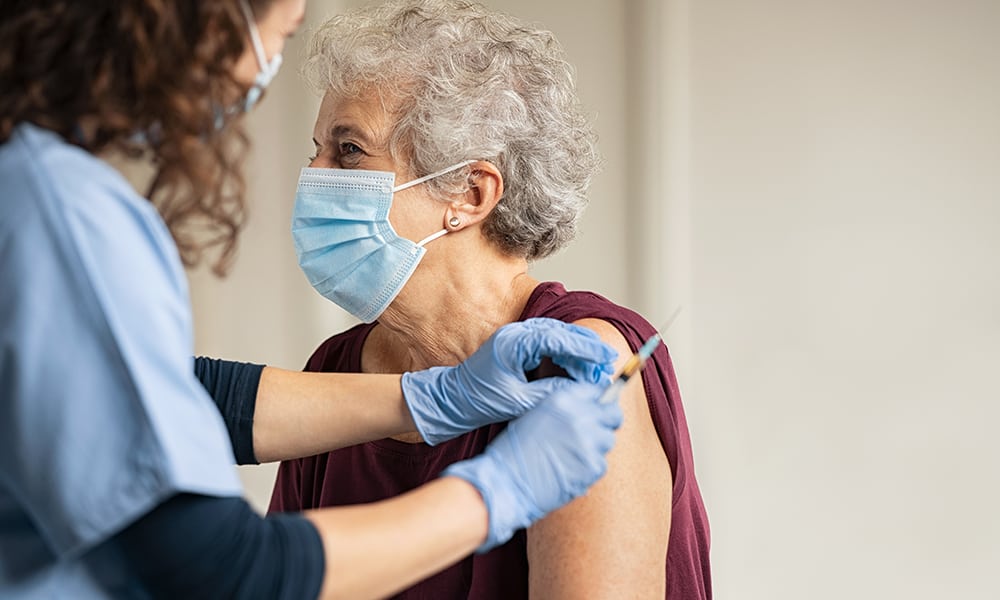 Woman receiving COVID-19 vaccine